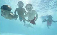 The Rex Family children playing in the pool under water
