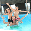 Father with his sons in a pool on his shoulders